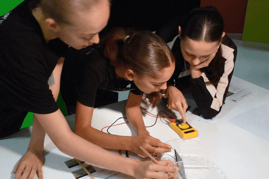 Three girls designing the solar car.